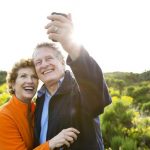 Caucasian couple taking picture outdoors